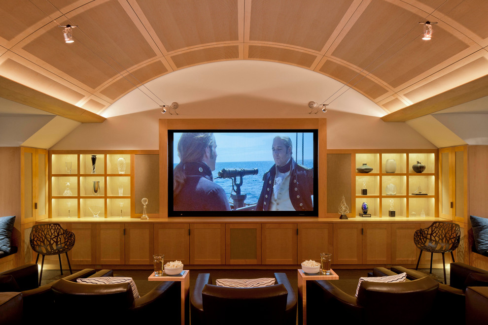 This is an example of a large contemporary enclosed home theatre in Boston with white walls, carpet and a projector screen.