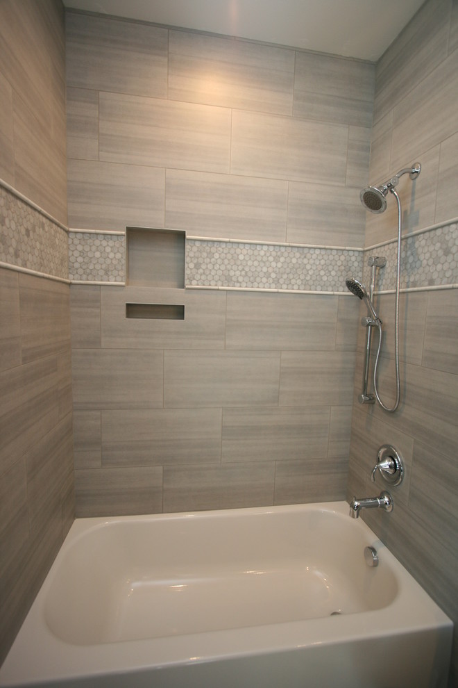 Photo of a mid-sized transitional bathroom in Seattle with an undermount sink, shaker cabinets, dark wood cabinets, engineered quartz benchtops, an alcove tub, an alcove shower, a two-piece toilet, white tile, porcelain tile, grey walls and porcelain floors.