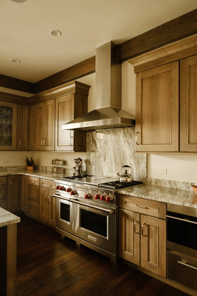 Open concept kitchen - large rustic u-shaped exposed beam open concept kitchen idea in Chicago with paneled appliances and an island