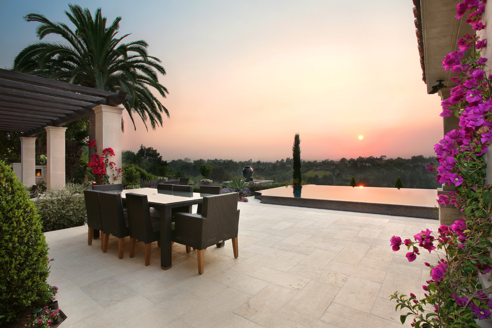 Design ideas for a mediterranean patio in Los Angeles with a pergola and a water feature.