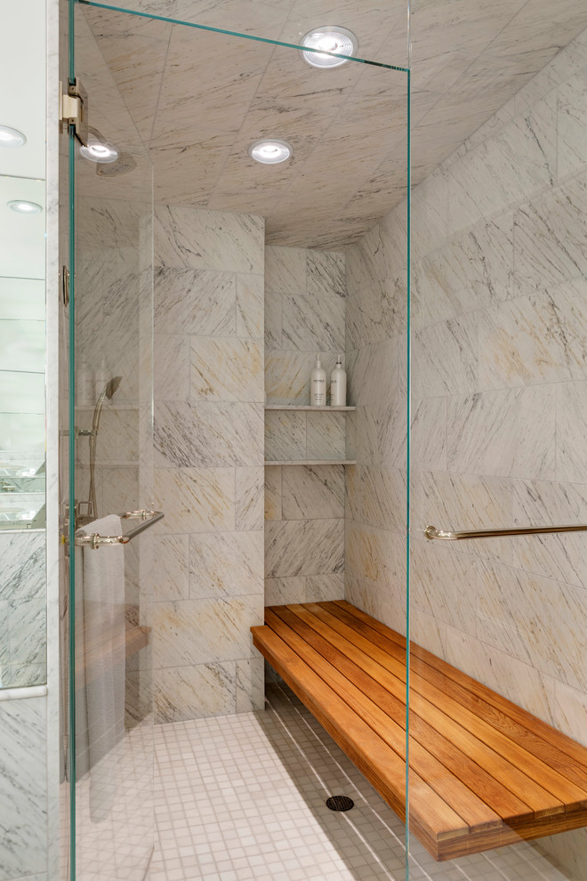 This is an example of a mid-sized transitional master bathroom in Boston with an alcove shower, beige tile, white tile, mosaic tile floors, a hinged shower door and a shower seat.