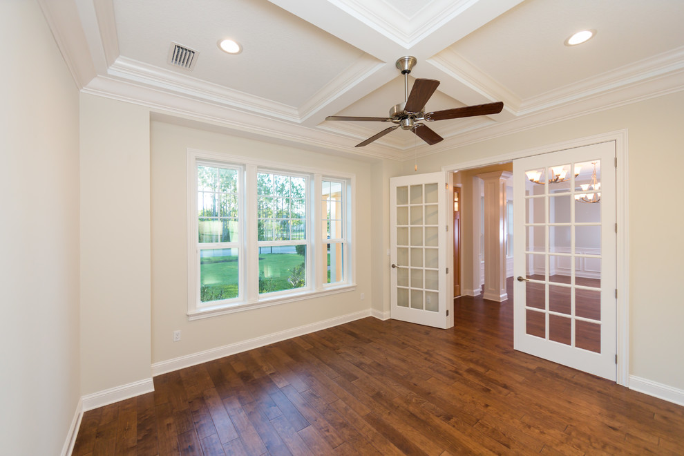 Mid-sized beach style study room in Jacksonville with beige walls, medium hardwood floors and no fireplace.