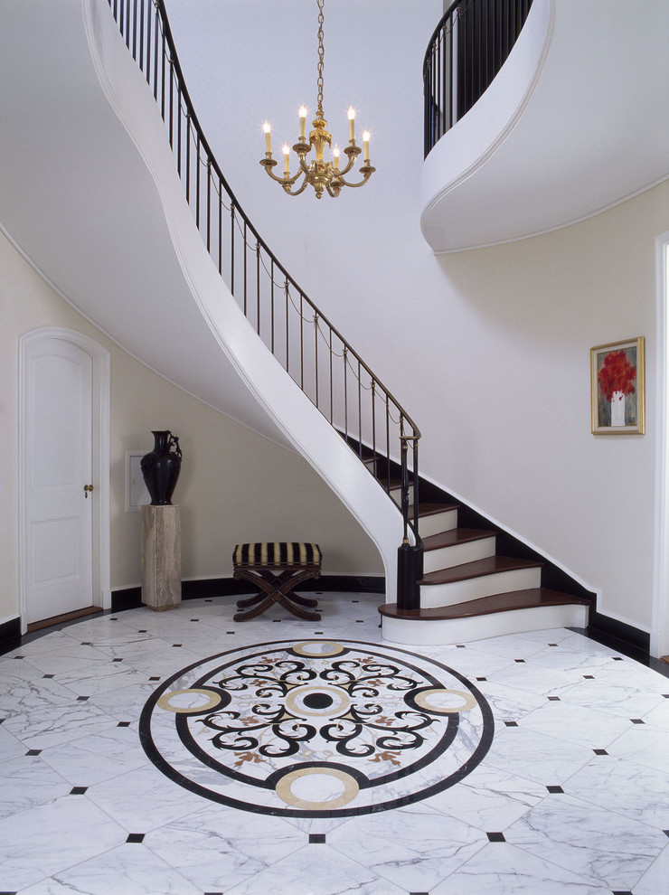 This is an example of an expansive traditional foyer in Santa Barbara with beige walls and marble floors.