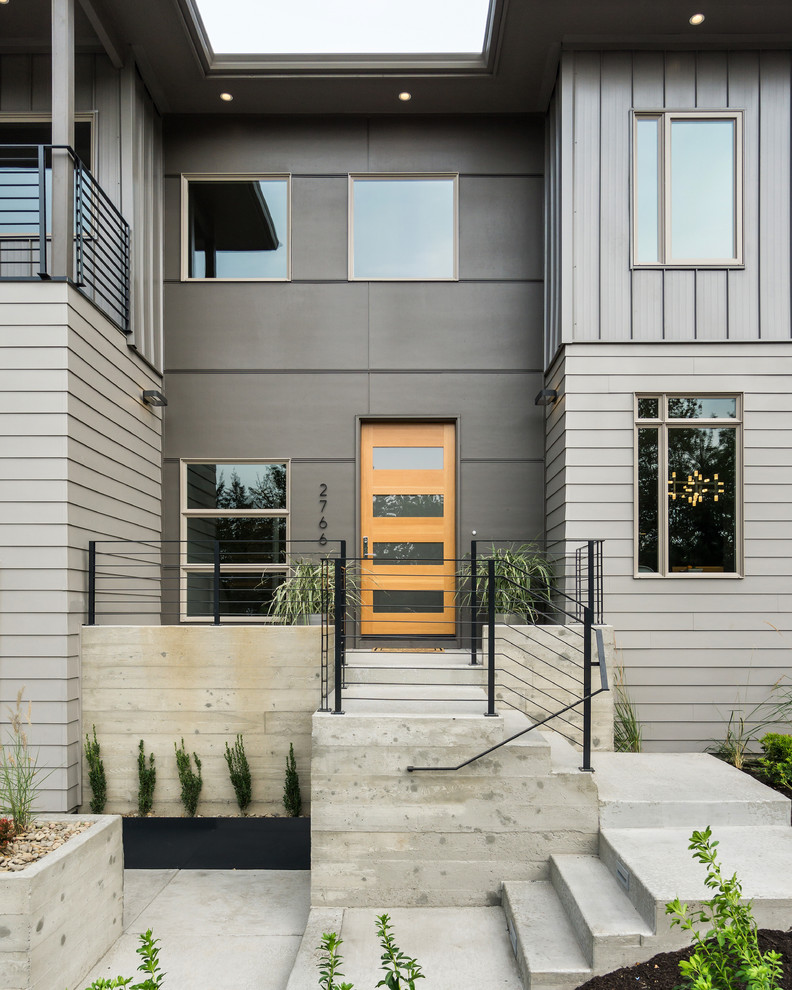Design ideas for an expansive modern two-storey grey exterior in Other with mixed siding.