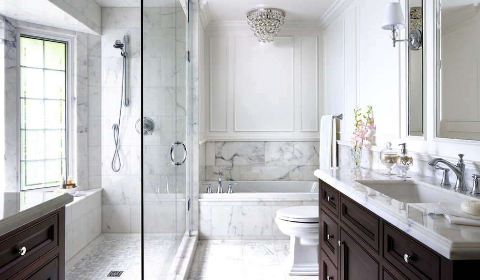 Photo of a mid-sized master bathroom in Other with furniture-like cabinets, dark wood cabinets, a claw-foot tub, an open shower, a bidet, white tile, marble, white walls, marble floors, an integrated sink, marble benchtops, white floor, a hinged shower door and white benchtops.