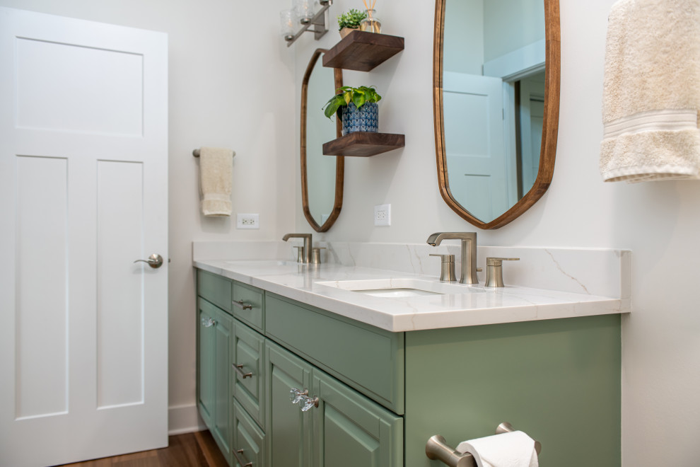 Photo of a medium sized classic ensuite bathroom in Chicago with shaker cabinets, green cabinets, a walk-in shower, a two-piece toilet, beige walls, porcelain flooring, a submerged sink, engineered stone worktops, brown floors, a sliding door, white worktops, double sinks and a built in vanity unit.