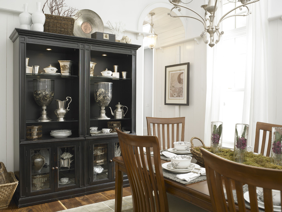 Design ideas for an eclectic dining room in Charlotte with white walls and dark hardwood floors.