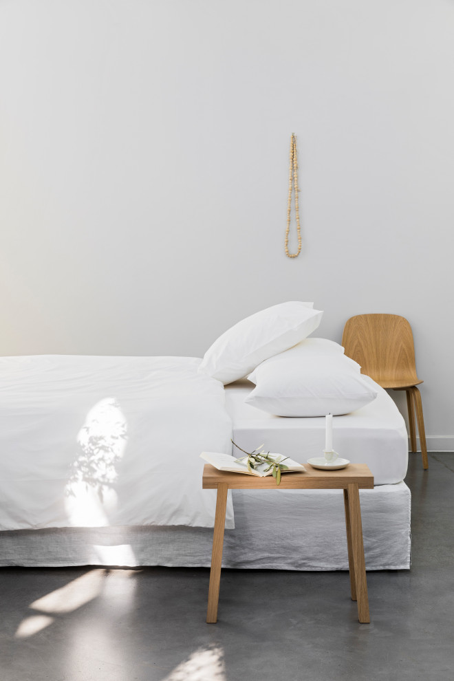 Bedroom - modern linoleum floor and gray floor bedroom idea in Paris with white walls