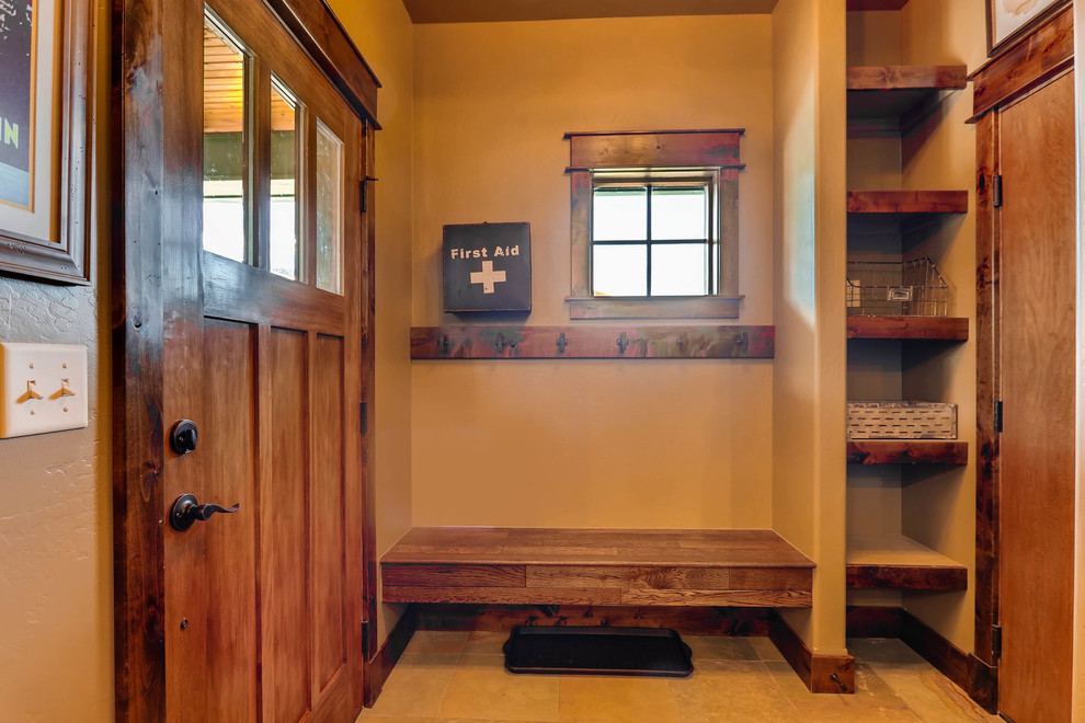 Small arts and crafts mudroom in Denver with brown walls, slate floors, a single front door, a brown front door and grey floor.