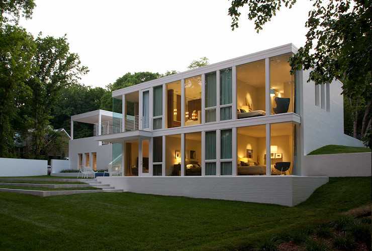 This is an example of a large modern one-storey brick white exterior in Nashville with a flat roof.