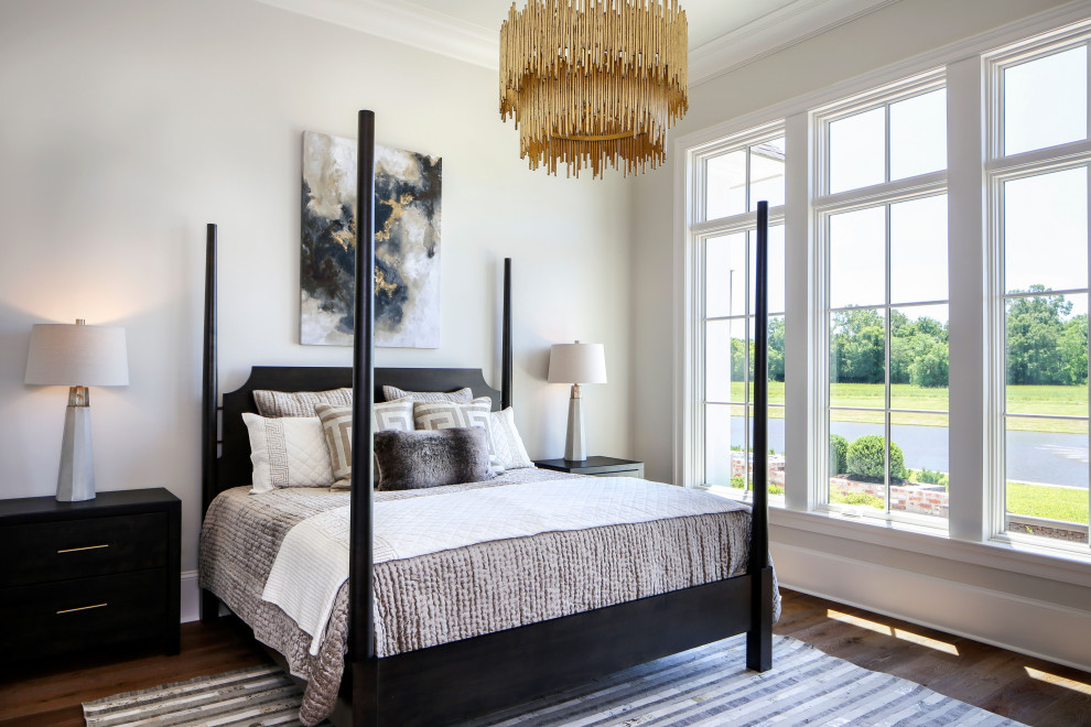 Inspiration for a mid-sized transitional master bedroom in New Orleans with white walls, medium hardwood floors and brown floor.