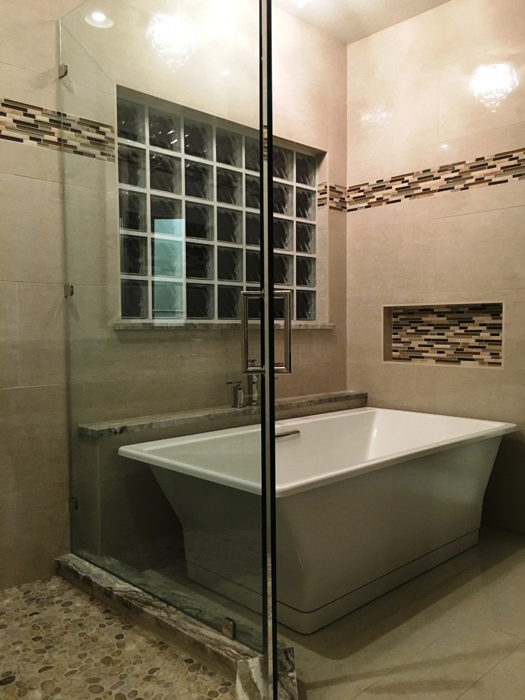Photo of a large contemporary master bathroom in Austin with beige tile, porcelain tile, a freestanding tub, a corner shower and porcelain floors.