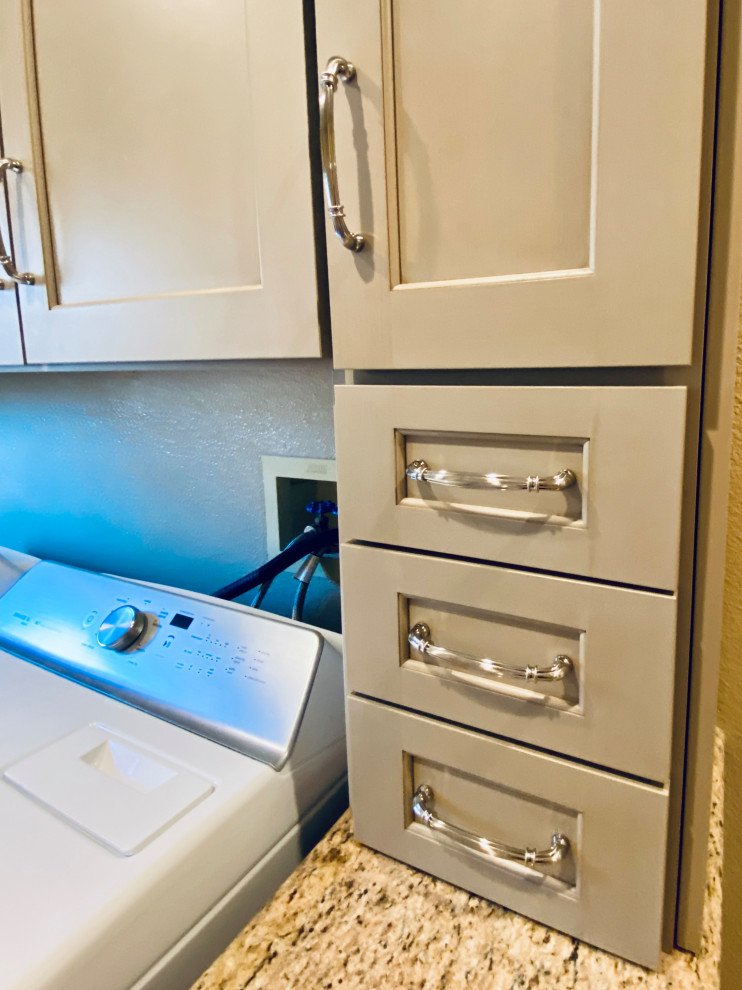 Photo of a mid-sized traditional u-shaped dedicated laundry room in San Francisco with an undermount sink, recessed-panel cabinets, beige cabinets, granite benchtops, beige splashback, stone slab splashback, beige walls, porcelain floors, a side-by-side washer and dryer, beige floor and beige benchtop.