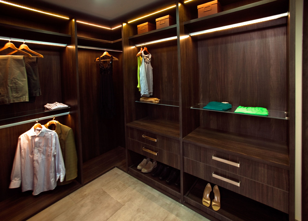Inspiration for a mid-sized contemporary gender-neutral walk-in wardrobe in Houston with flat-panel cabinets, dark wood cabinets and ceramic floors.