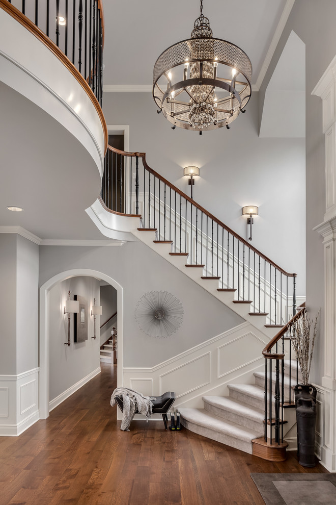 Inspiration for a large transitional foyer in Seattle with grey walls, dark hardwood floors, a single front door, a white front door and brown floor.