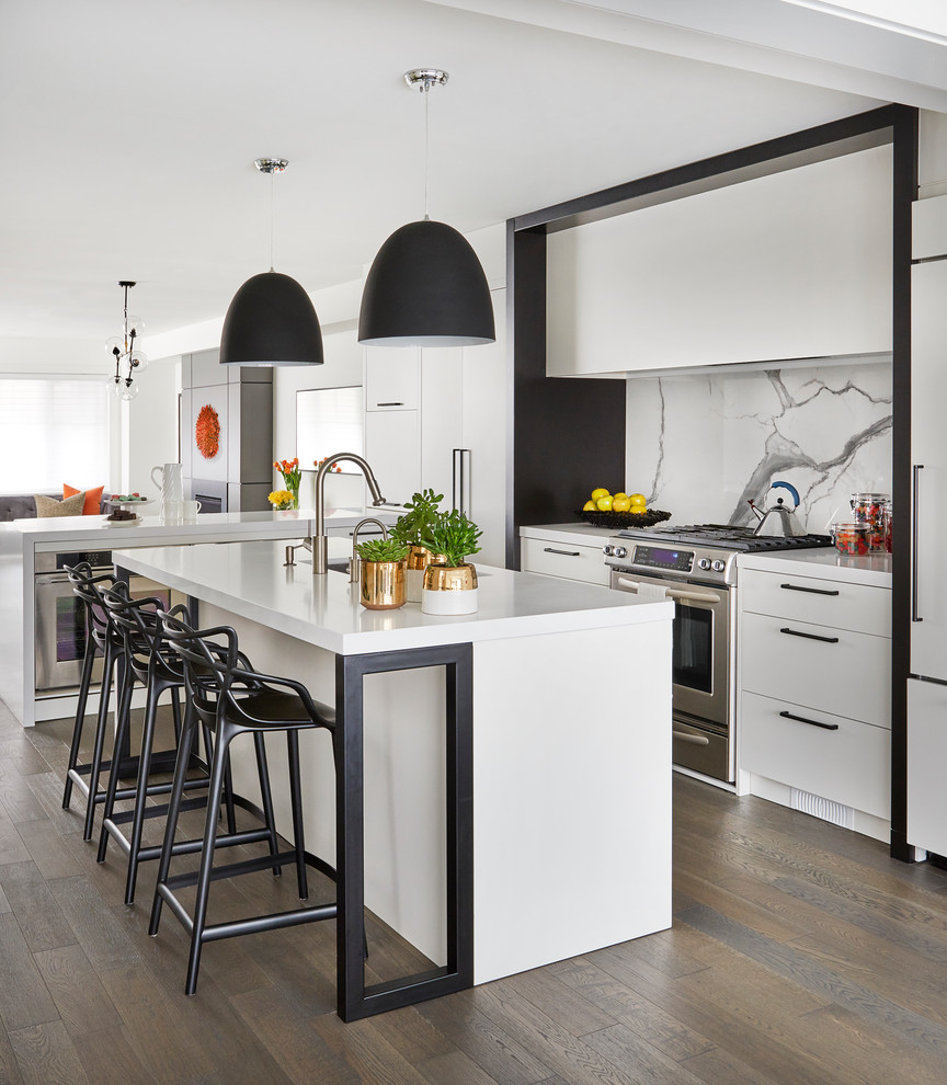 Example of a small trendy l-shaped medium tone wood floor and brown floor open concept kitchen design in Toronto with an undermount sink, flat-panel cabinets, white cabinets, quartz countertops, white backsplash, stone slab backsplash, an island and stainless steel appliances