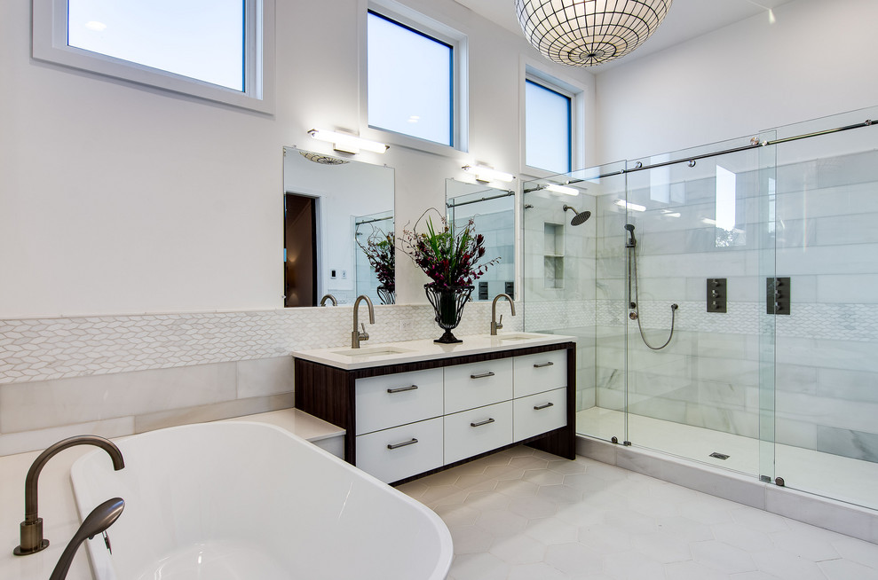 Inspiration for an expansive contemporary master bathroom in Portland with flat-panel cabinets, white cabinets, a freestanding tub, white tile, porcelain tile, white walls, ceramic floors, engineered quartz benchtops, white floor, a sliding shower screen, white benchtops, an alcove shower, an undermount sink, a double vanity and a freestanding vanity.