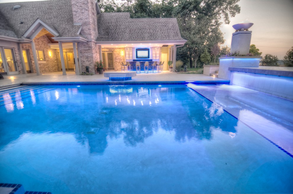 Inspiration for a large transitional backyard concrete paver and rectangular natural hot tub remodel in Cedar Rapids