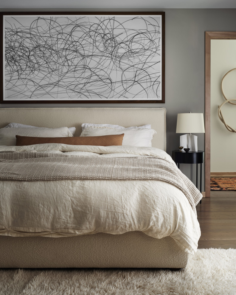 Trendy dark wood floor and brown floor bedroom photo in Milwaukee with gray walls