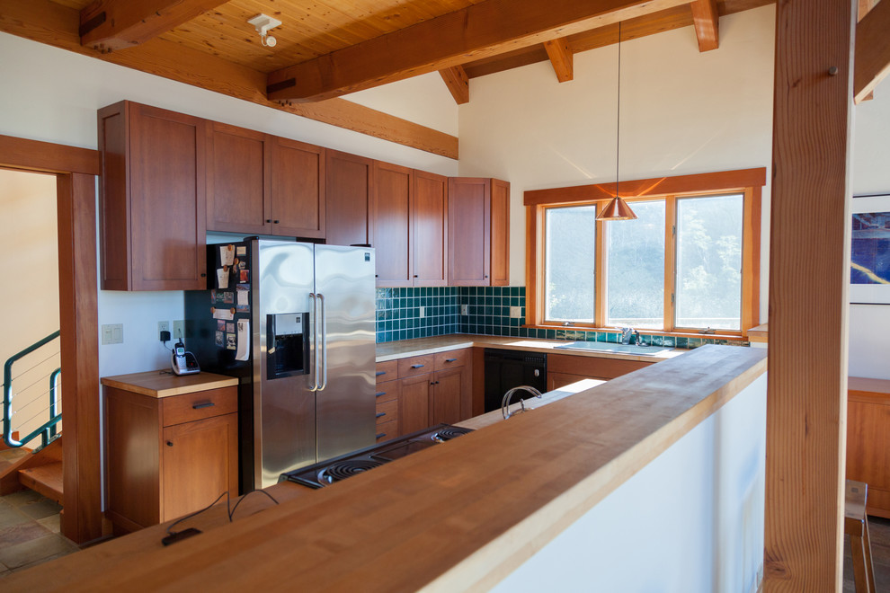 Mountain style kitchen photo in Seattle with a drop-in sink, shaker cabinets, dark wood cabinets and stainless steel appliances