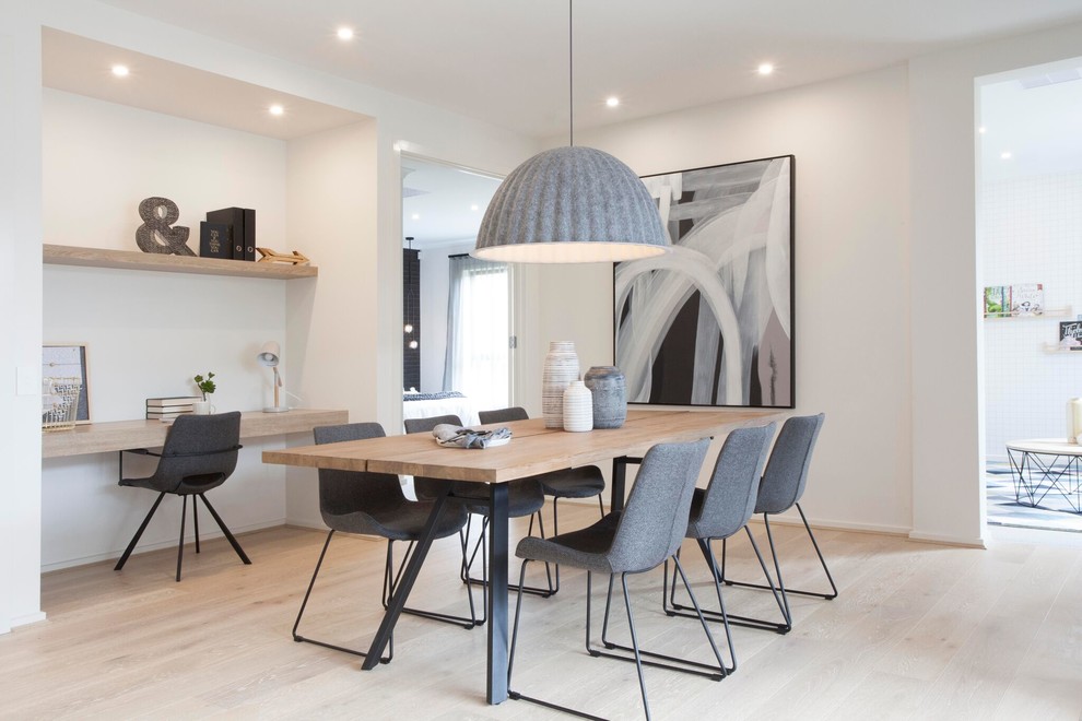 This is an example of a contemporary dining room in Melbourne with white walls, light hardwood floors and beige floor.