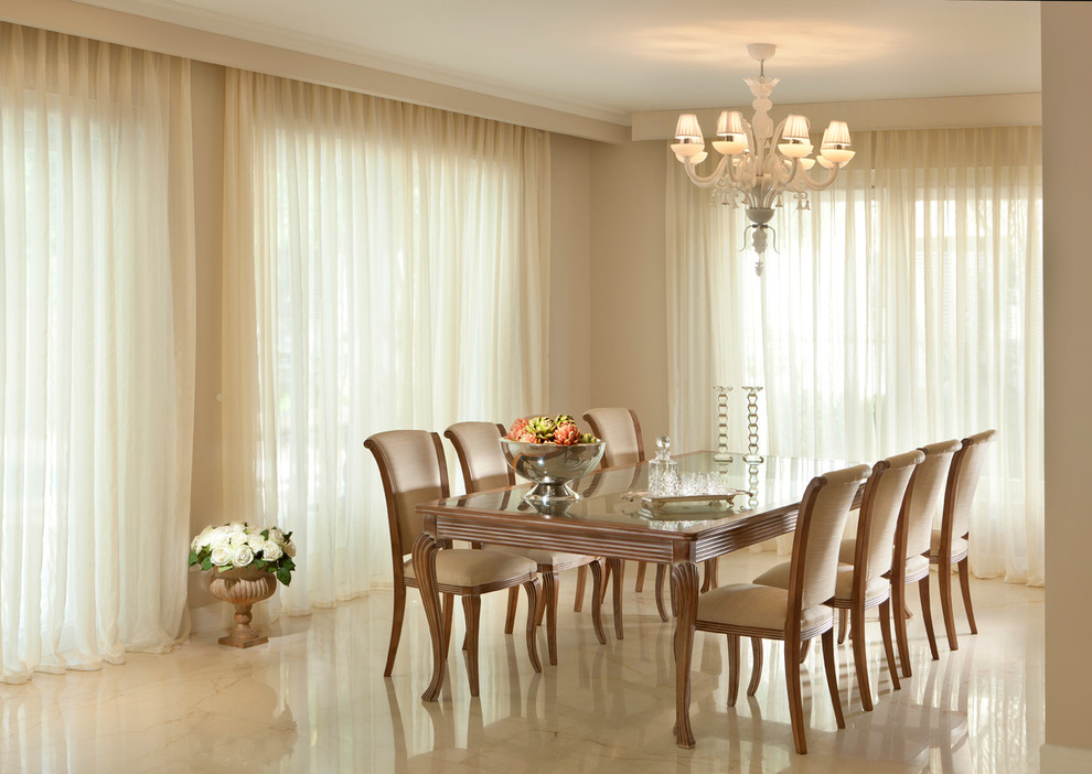 This is an example of a contemporary dining room in Other with beige walls and marble floors.