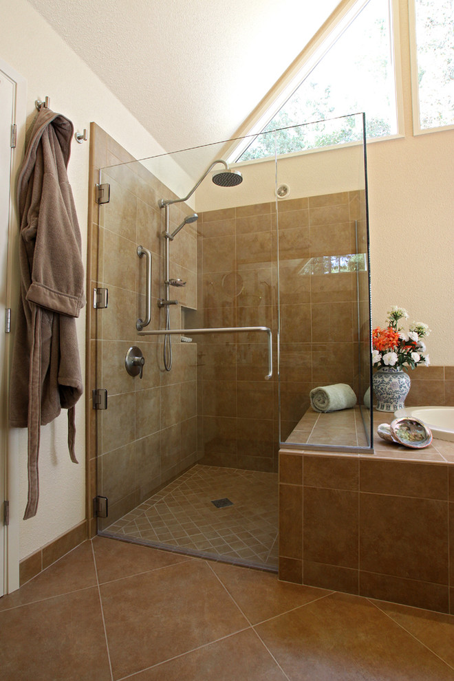 This is an example of a traditional master bathroom in San Francisco with a drop-in tub, a corner shower, brown tile, ceramic tile, beige walls and ceramic floors.