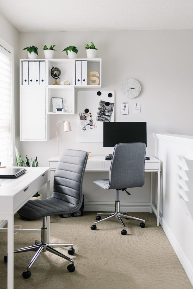 Danish freestanding desk carpeted and beige floor study room photo in Edmonton with white walls