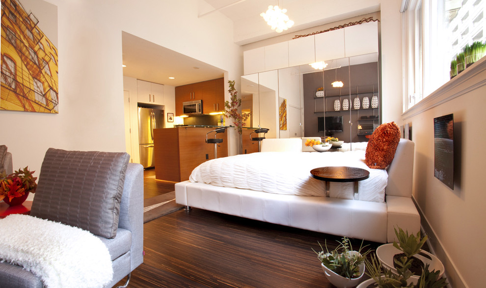 Modern bedroom in Los Angeles with beige walls and dark hardwood floors.
