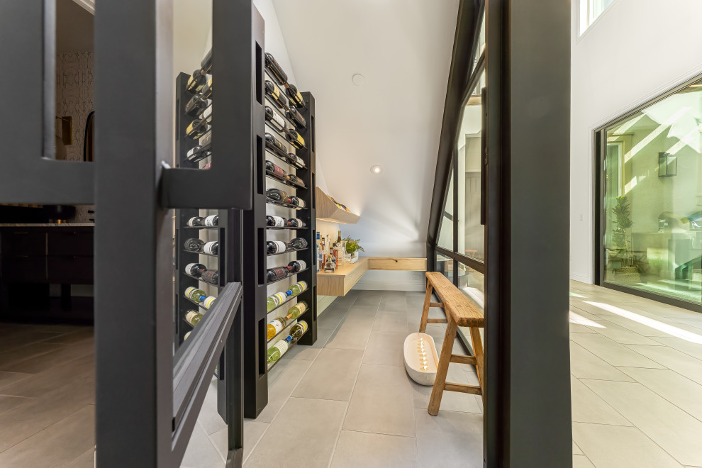 Inspiration for a small contemporary wine cellar in Los Angeles with porcelain floors, display racks and grey floor.