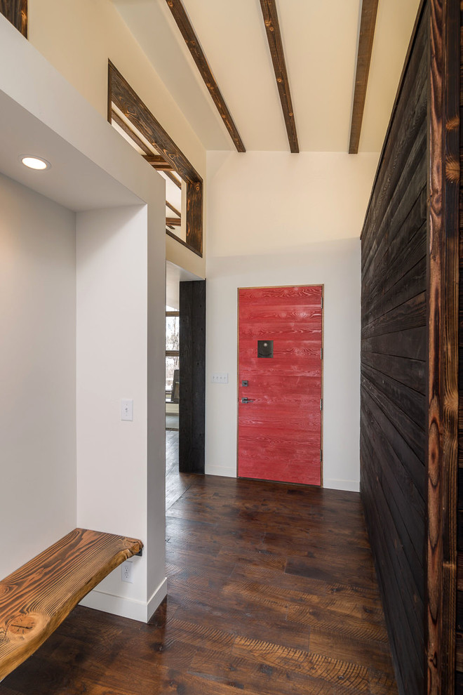 Entry hall - contemporary medium tone wood floor entry hall idea with white walls and a red front door