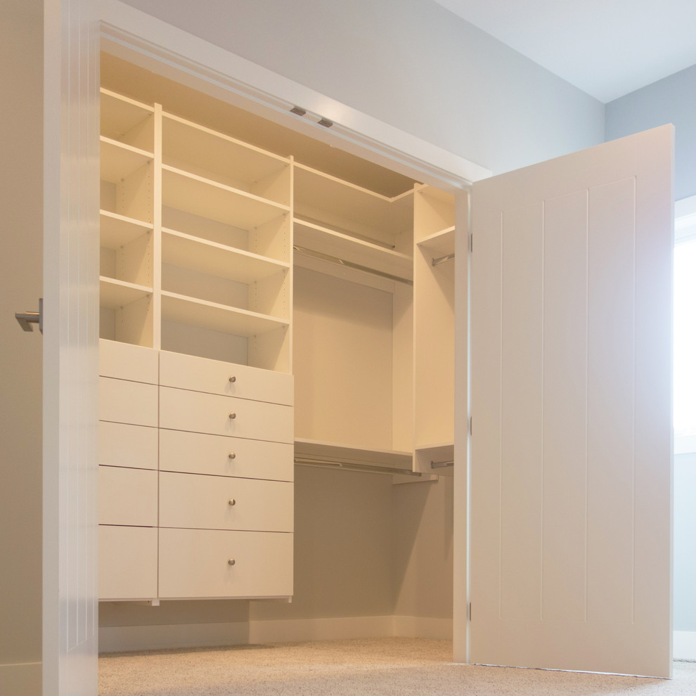 Inspiration for a mid-sized transitional gender-neutral carpeted walk-in closet remodel in Vancouver with flat-panel cabinets and white cabinets