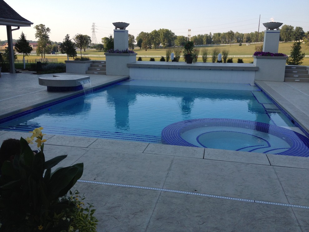 Example of a large transitional backyard concrete paver and rectangular natural hot tub design in Cedar Rapids
