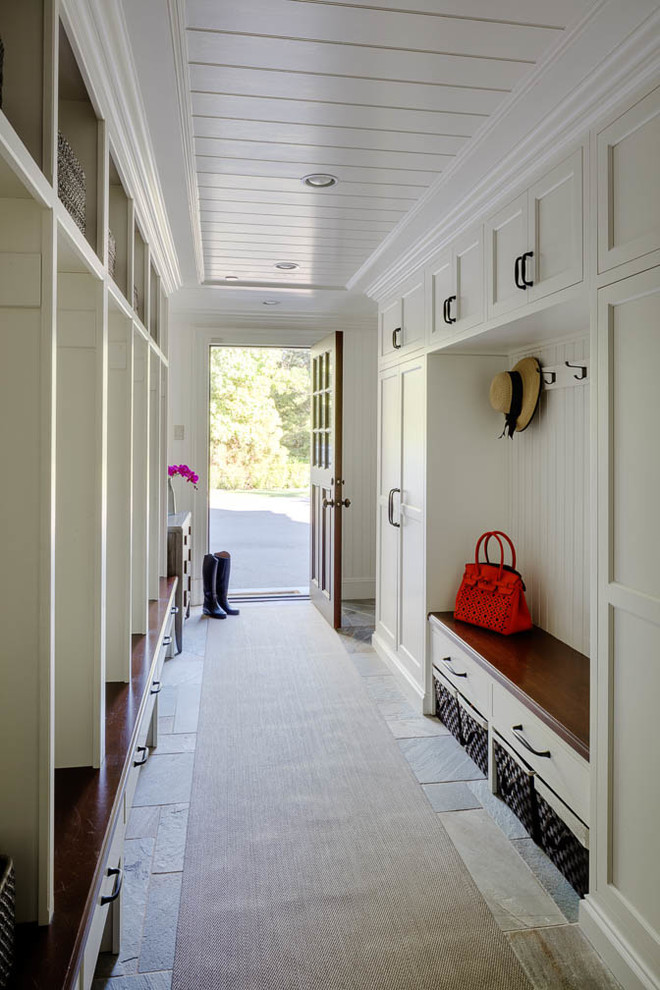 Expansive traditional mudroom in Boston with white walls, slate floors, a single front door and a brown front door.