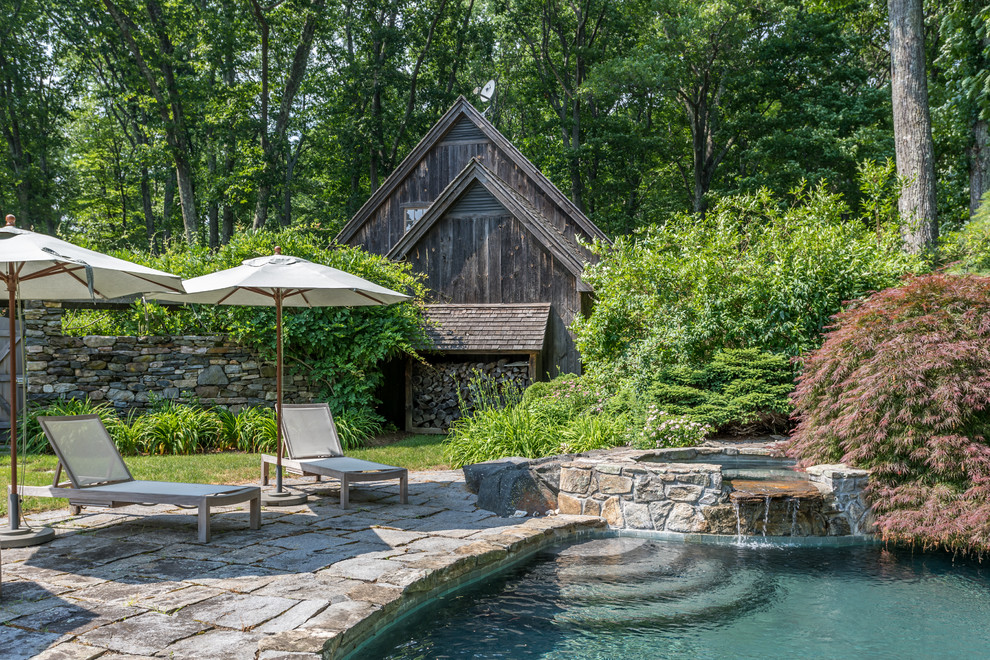 Photo of a country backyard custom-shaped lap pool in New York with a hot tub.