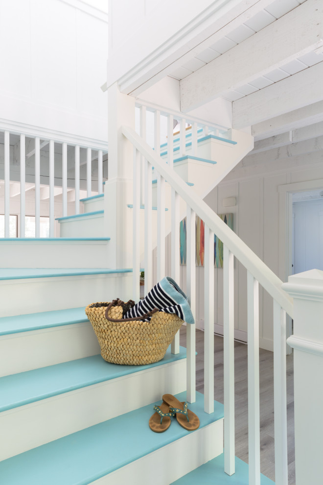 Design ideas for a beach style painted wood staircase in Boston with painted wood risers and wood railing.