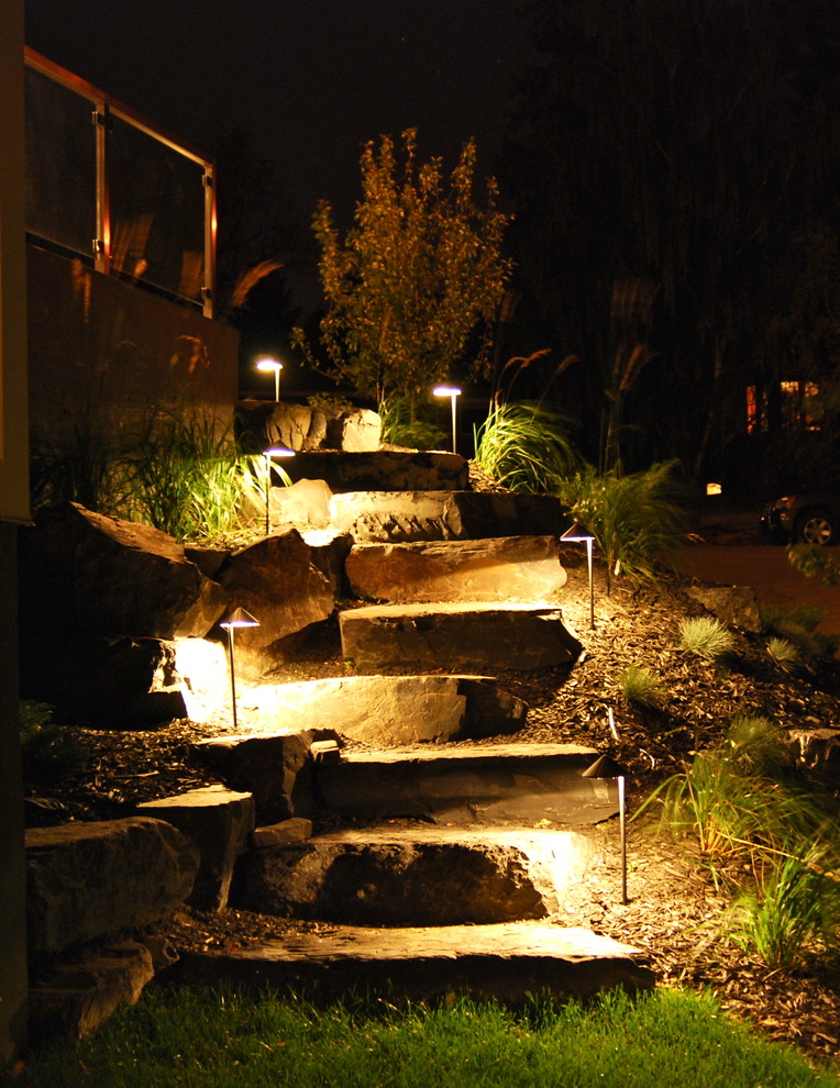 Photo of a mid-sized rustic front yard concrete paver garden path in Calgary.