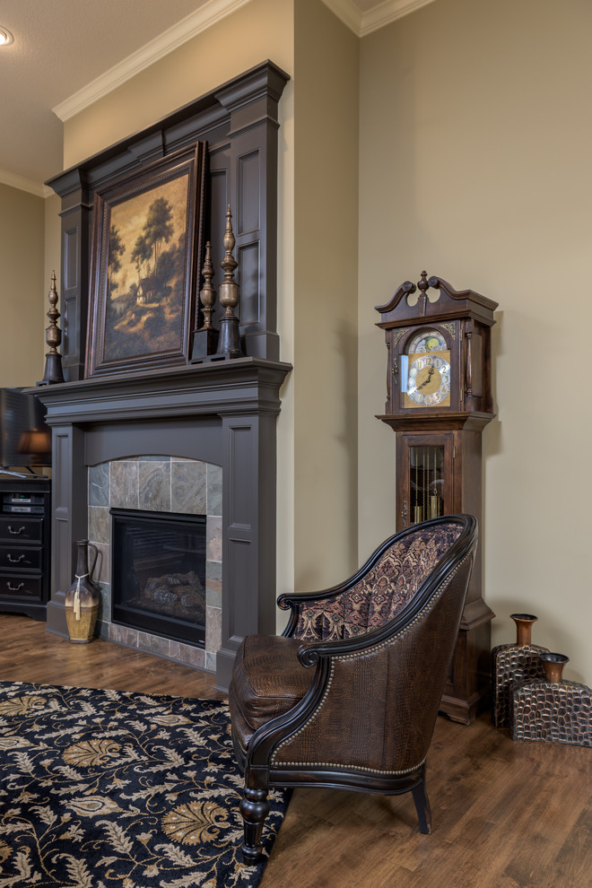 Inspiration for a mid-sized traditional formal open concept living room in Kansas City with beige walls, light hardwood floors, a standard fireplace, a tile fireplace surround and a freestanding tv.