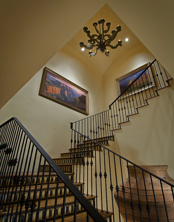 Inspiration for a large mediterranean wood curved staircase in Phoenix with tile risers.