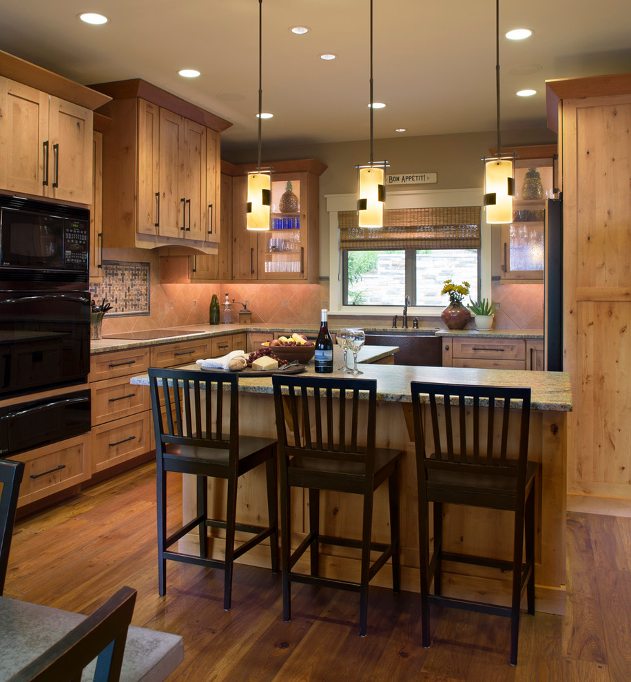 Kitchen - rustic u-shaped medium tone wood floor kitchen idea with a farmhouse sink, shaker cabinets, light wood cabinets, granite countertops, ceramic backsplash, black appliances, beige walls and an island