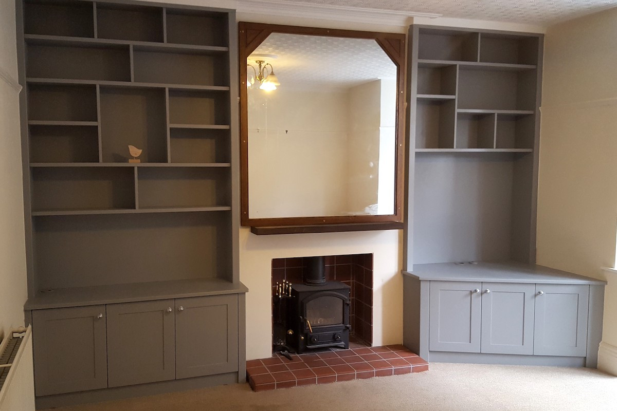 Wide Alcove Cabinets in Grey with Asymmetrical Shelving and Angled Cabinets