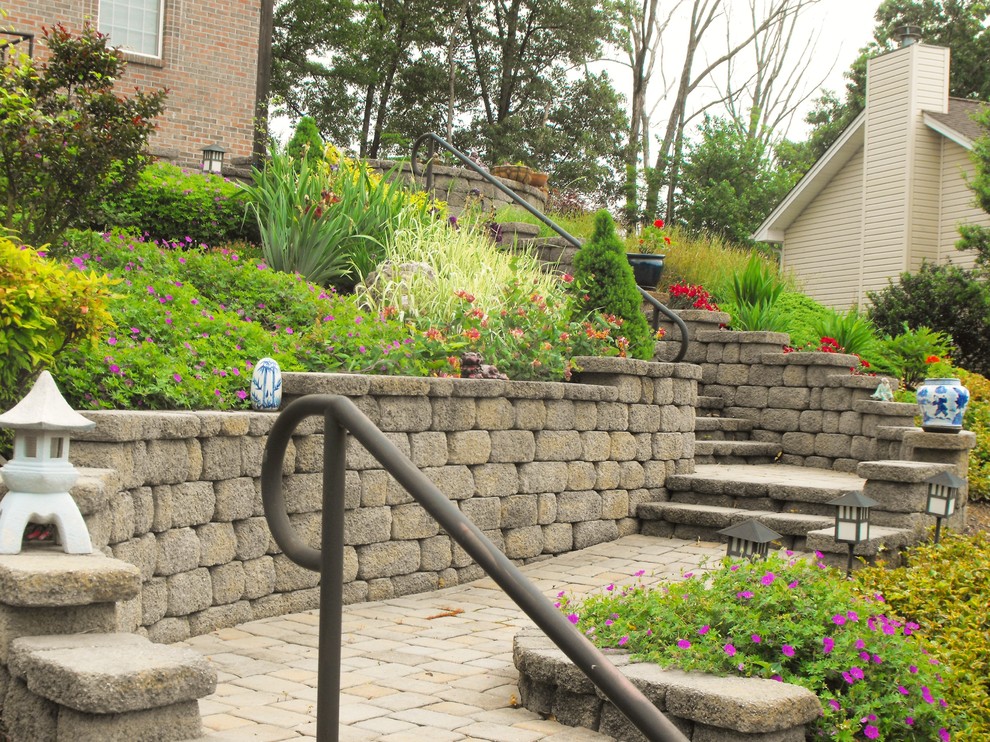 Photo of a mid-sized asian sloped full sun formal garden in Other with a garden path and concrete pavers.