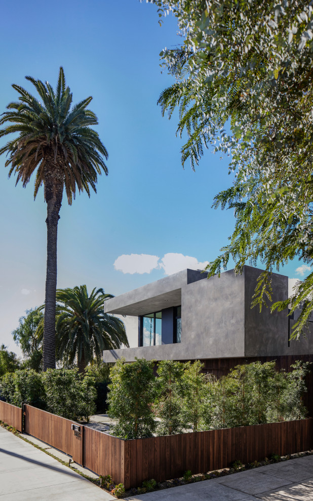 Large and gey modern two floor render detached house in Los Angeles with a flat roof.