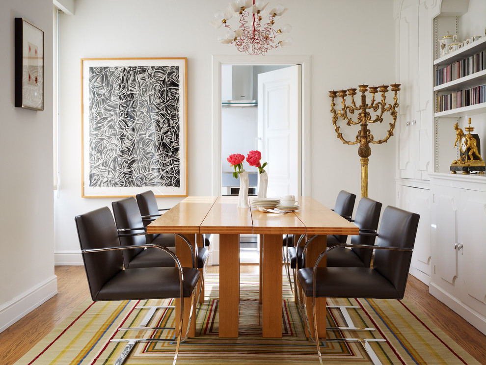 Photo of a modern separate dining room in San Francisco with white walls and medium hardwood floors.