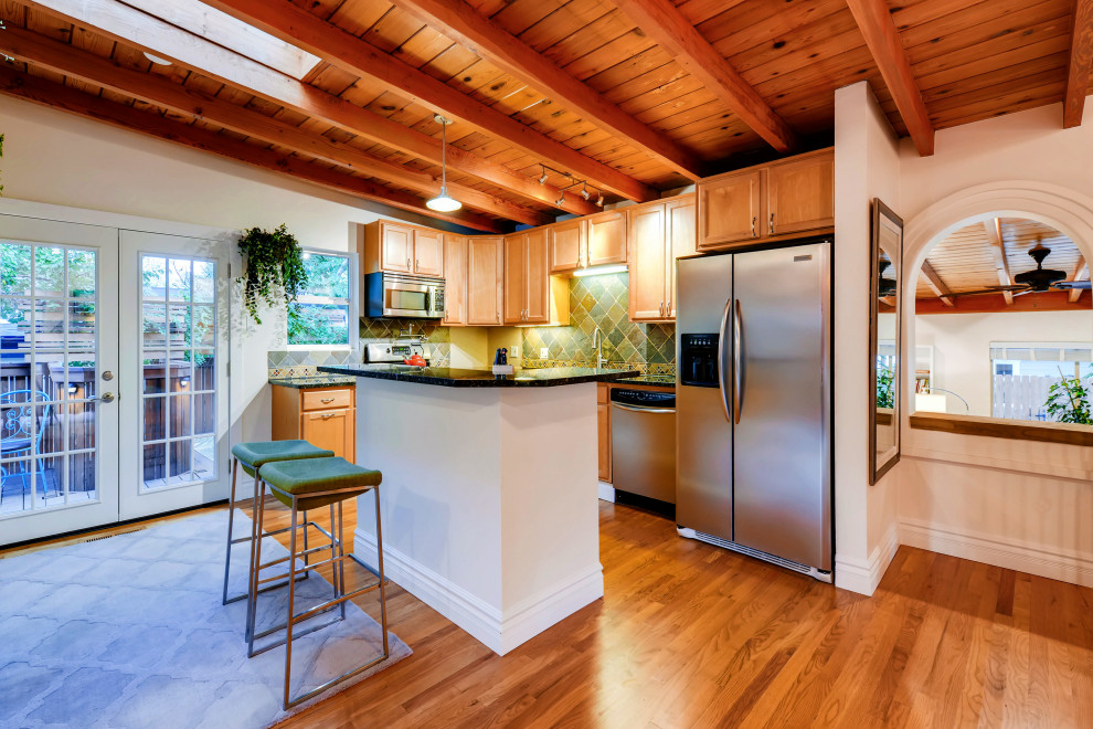 Inspiration for a large contemporary eat-in kitchen in Denver with a drop-in sink, light wood cabinets, granite benchtops, stone tile splashback, stainless steel appliances, medium hardwood floors, with island and green benchtop.