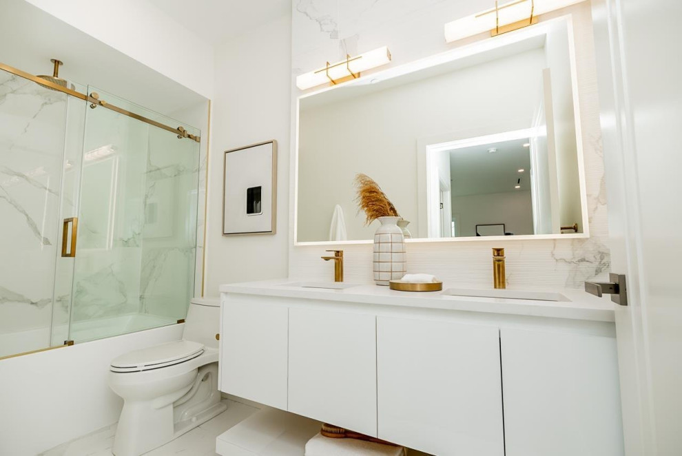 Small transitional master multicolored tile and ceramic tile ceramic tile, white floor and double-sink alcove bathtub photo in Vancouver with flat-panel cabinets, white cabinets, a one-piece toilet, white walls, an undermount sink, quartzite countertops, white countertops and a floating vanity