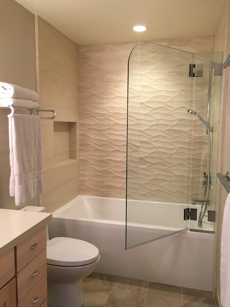 Design ideas for a mid-sized contemporary bathroom in San Francisco with an undermount sink, shaker cabinets, medium wood cabinets, engineered quartz benchtops, an alcove tub, a shower/bathtub combo, beige tile, porcelain tile, beige walls and porcelain floors.