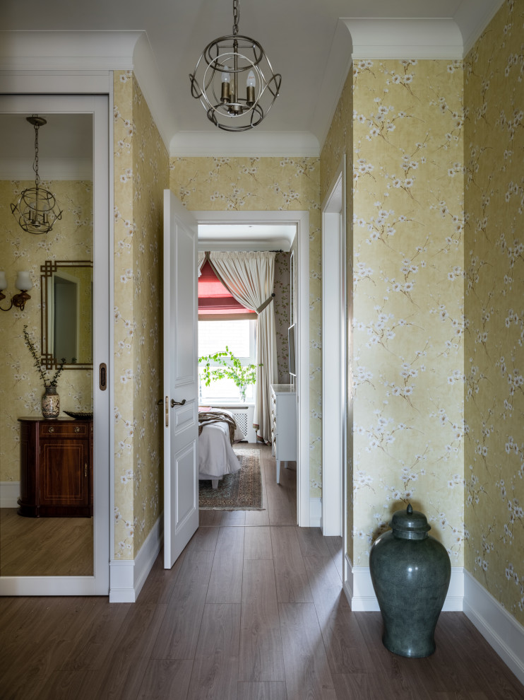 Réalisation d'un couloir champêtre de taille moyenne avec un mur jaune, sol en stratifié, un sol beige et du papier peint.