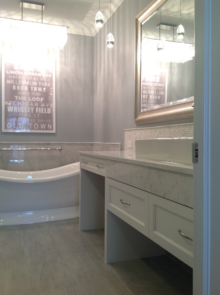 Photo of a mid-sized traditional master bathroom in Chicago with flat-panel cabinets, white cabinets, a freestanding tub, gray tile, stone tile, grey walls, porcelain floors, engineered quartz benchtops and a vessel sink.