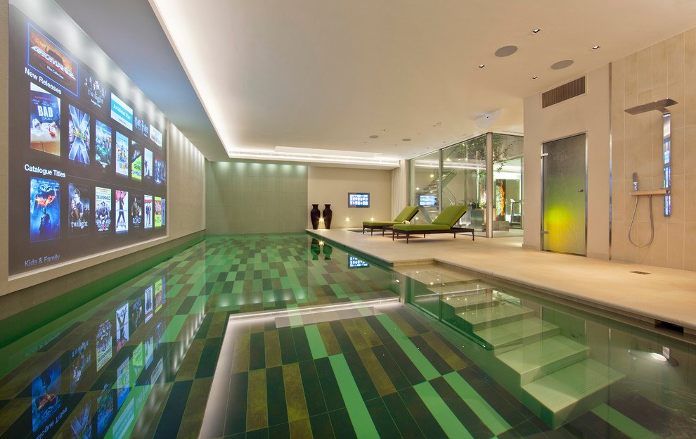 Photo of a contemporary indoor rectangular pool in London with a pool house.